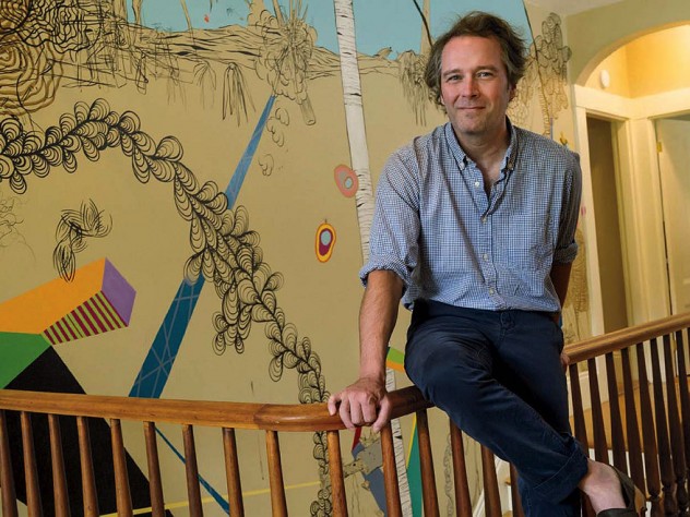 Dan Chiasson at home in front of a “sometimes delightful, sometimes disturbing” mural by David Teng Olsen, which appears in The Math Campers.