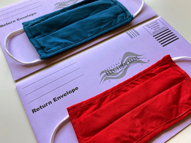 photograph of two election mail envelopes with face masks