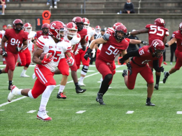 Harvard senior linebacker Jack McGowan (54) and sophomore safety Victor Tademy chase down Cornell runner SK Howard.
