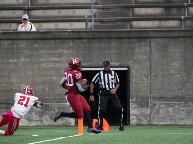 Harvard junior running back Aaron Shampklin eludes the desperate lunge of Cornell's Kenan Clarke to score the clinching touchdown.