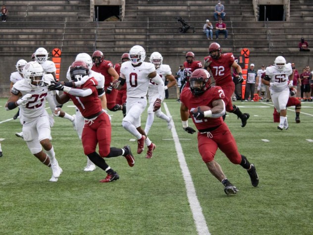 Running back Aidan Borguet runs up field with ball in hand