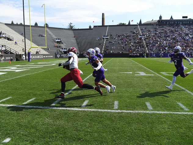 Kym Wimberly runs down the sideline with ball in hand.