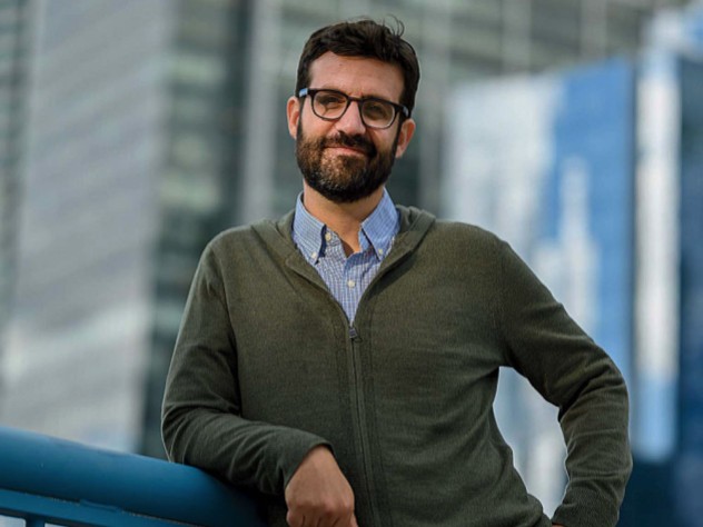 Bruno Carvalho stands in front of a city background