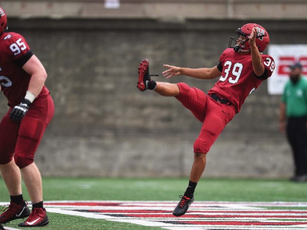 Jon Sot punts a football.