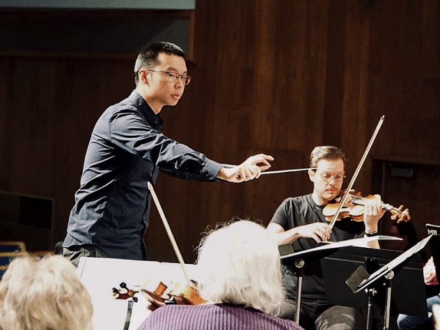 Sam Wu conducts an orchestra
