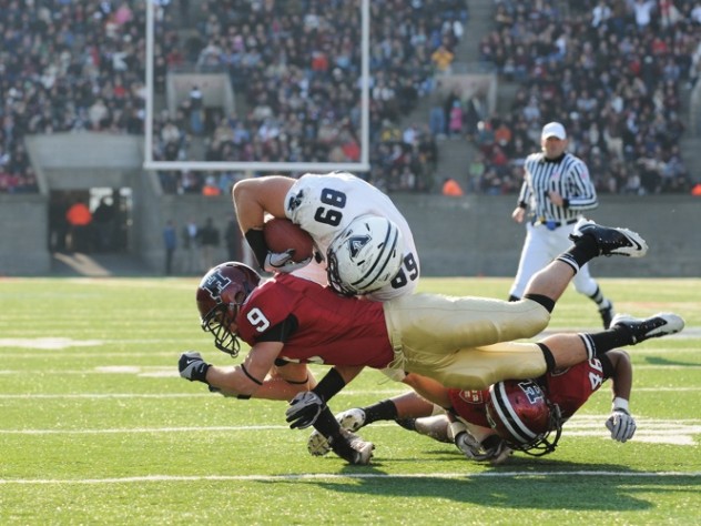 Photograph by Meredith Keffer Cornerback Dan Minamide ’12 (9) and linebacker Alexander Norman ’13 (46) cut down end Chris Blohm after a three-yard pass reception in the second quarter.