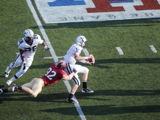 Photograph by Meredith Keffer Yale quarterback Patrick Witt, the Ivy League’s top passer, was sacked six times by Harvard defenders. End Ryan Burkhead ’11 (92) had a career-high 2.5 sacks for a net loss of 20 yards. The Eli behind Burkhead is running back Mordecai Cargill.