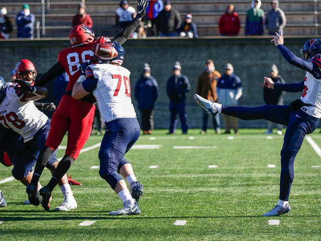 Penn's kicker, Jake Haggard, punts the football.