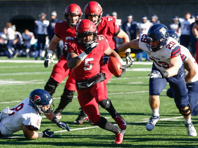 Harvard wideout B.J. Watson runs upfield, ball in hand.