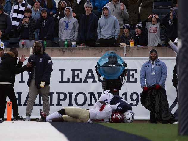 Kym Wimberly holds the ball as a Yale defender tries to peel it from his hands.