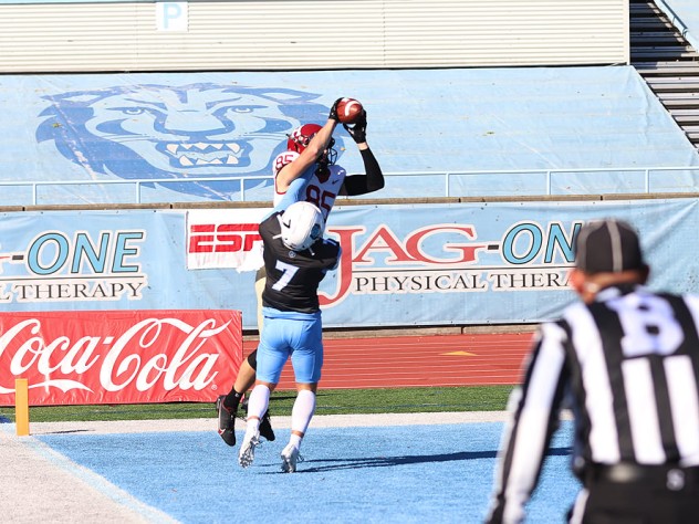 Receiver Adam West makes a leaping catch over a Columbia defender.