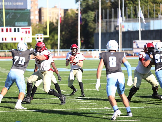 Quarterback Luke Emge takes the snap and looks upfield.