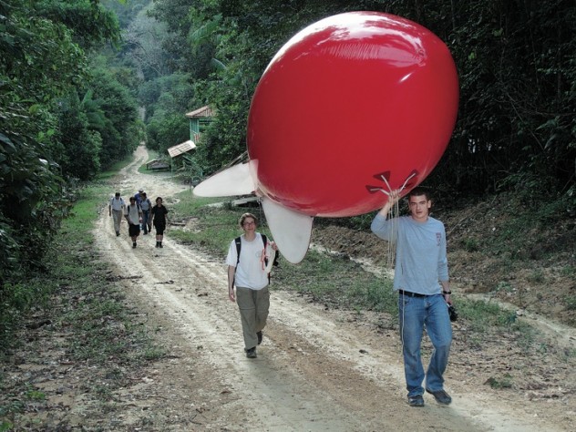 Newell and Horowitz walk the weather balloon to the launch site