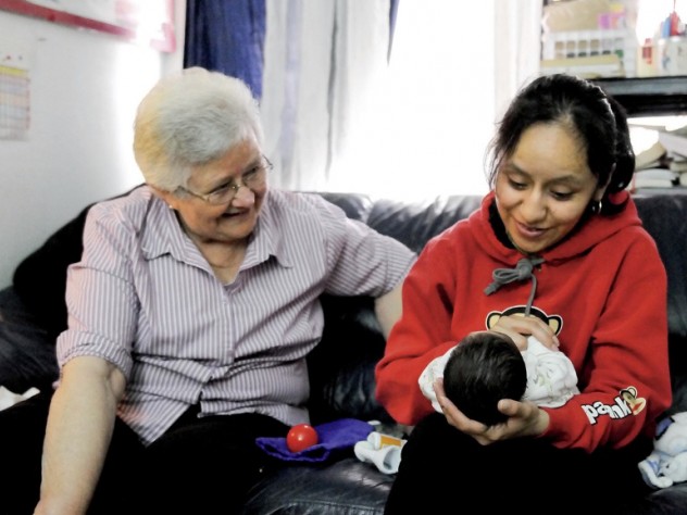 In East Harlem, Susana Saldivar and her son Xavier receive a visit from Sister Suzanne Deliee, a nurse with Little Sisters of the Assumption Family Health Service.