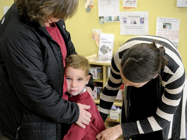 Photograph by Stu Rosner In Dorchester, Liam Denver has a hard time saying goodbye to his mother, Kim, as teacher Carolyn Christopher offers comfort.