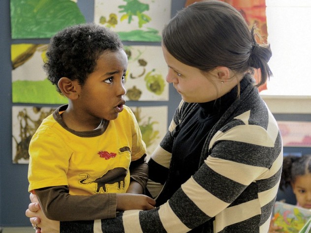Photograph by Stu Rosner Teacher Carolyn Christopher comforts Joshua Medicke after his mother leaves.