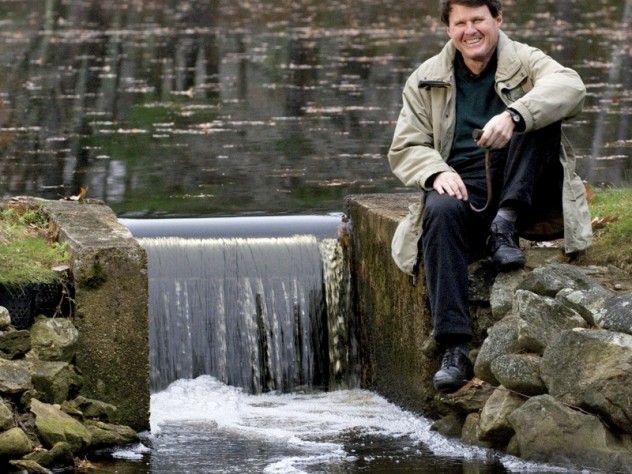 Photograph by Jim Harrison When not dealing with major global water issues, John Briscoe manages this small dam near his home. He holds the hook used to open the sluice gate.