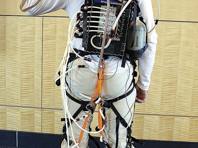 The actuator box, carried in the wearer's backpack, provides well-timed bursts of power that are transmitted to exosuit components strapped at the user's knee and ankle joints.