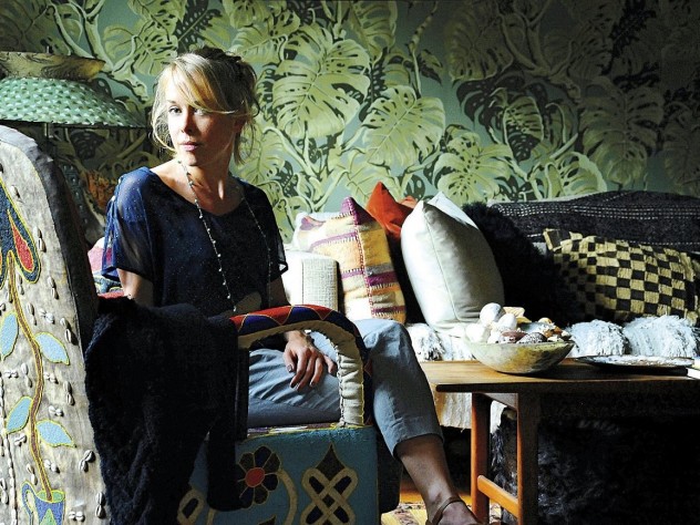 Anna Laurent backed by wallpaper showing split-leaf philodendron (<i>Monstera deliciosa</i>)