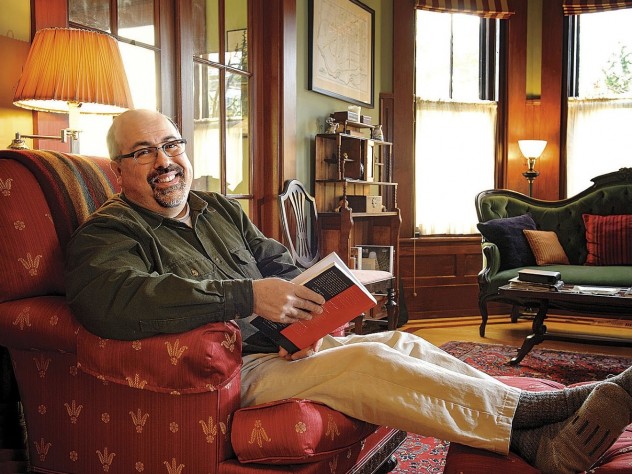 Poet and physician Rafael Campo relaxes at home with a book. 