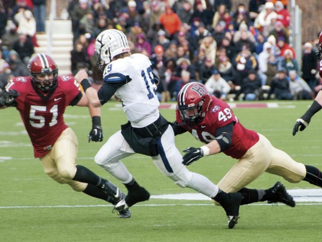 Photograph by Robert Worley As so often happened this season, an opposing quarterback—in this case, Yale’s Morgan Roberts—had nowhere to run against marauding Crimson defenders such as linebackers Jake Lindsey ’16 (number 51) and Eric Medes ’16 (number 49), who were helped by defensive tackle Miles McCollum ’17.