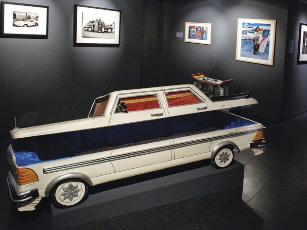 A Mercedes-shaped &ldquo;fantasy coffin&rdquo; by Samuel Kane Kwei reveals its blue fabric interior.