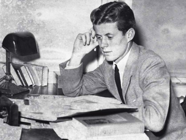 Archival photograph of John F. Kennedy as an undergraduate, circa 1939, studying papers