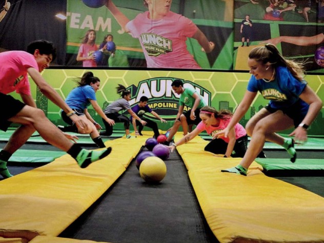 People playing dodgeball on indoor trampolines 