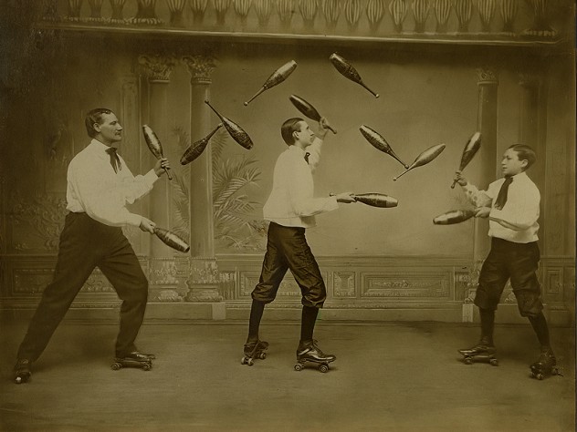 Three men juggle while roller-skating