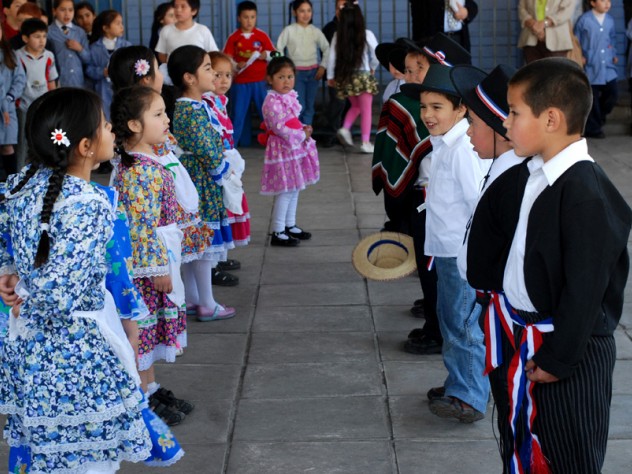 Children perform "cuecas," a Chilean traditional dance, for visitors including Harvard professors who helped design UBC.