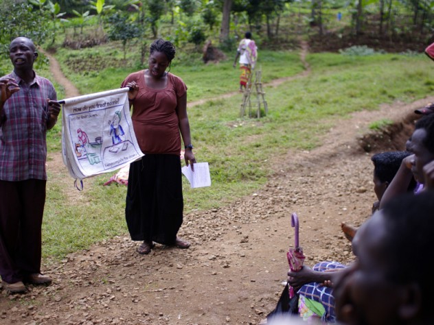 Photograph by Ian MacLellan Kiahana Brooks ’10 (right) teaches about malaria prevention and treatment to patients waiting to be seen at the clinic. Clinic worker Richard Kimanayi, left, translates.