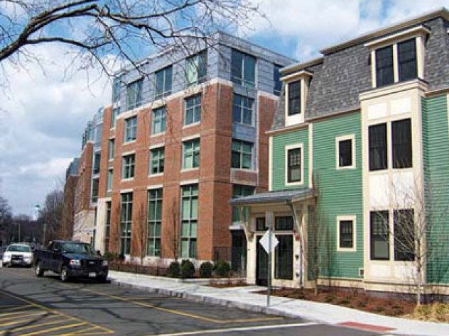 A new wood-frame building on Cowperthwaite Street softens the profile of a six-story brick-and-glass apartment complex.