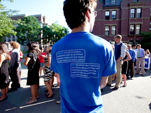 Photograph by Rose Lincoln/Harvard News Office Peer advising fellows in blue tees and members of the Crimson Key Society in red tees cheered on the first-years entering Tercentenary Theatre.