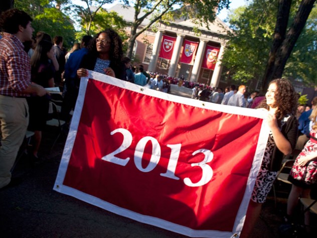 Photograph by Justin Ide/Harvard News Office Seniors Kia J. McLeod (left) and Andrea R. Flores, vice president and president of the Undergraduate Council, display the banner that they presented to the class of 2013.