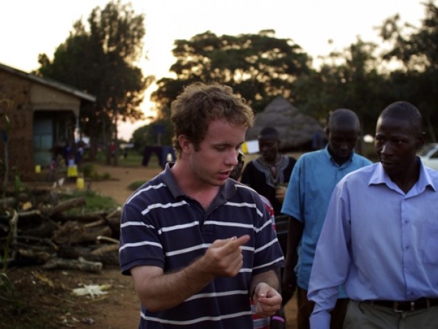 Photograph by Ian MacLellan Higgins talks with Mulago about the income-generating projects he helped start last summer at New Hope (including raising pigs, chickens, and cows; growing sweet potatoes; and operating an Internet café).