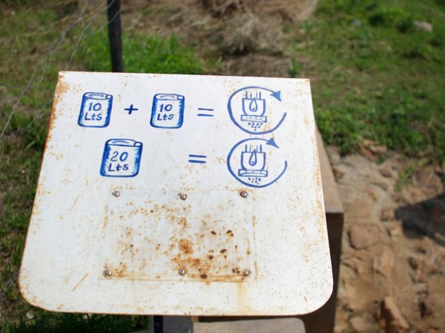 Photograph by Ian MacLellan IPA hopes local residents will make a habit of adding chlorine to their water each time they collect it. Simple directions on the dispenser serve as a reminder.