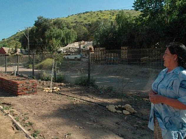 Ana Lamilla surveys the Renca development from the still-under-construction park on a ridge above. Behind her, part of the squatter settlement where she once lived remains.