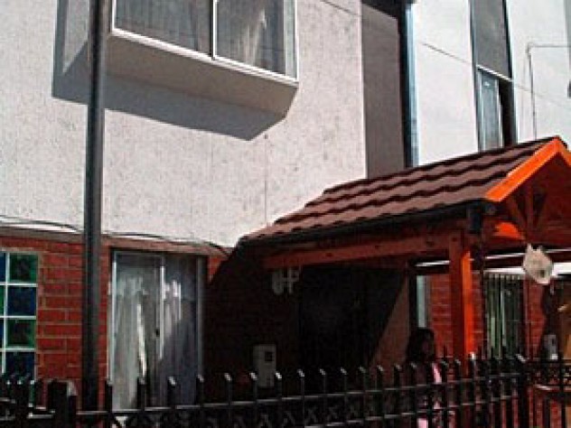 The units also had no-frills front yards in their original condition; the Huertas embellished their windows and added a fence, a bench, and an ornamental awning.