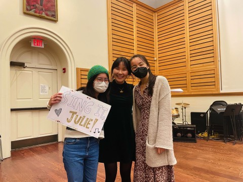 The author and two friends smiling in Holden Chapel together after her performance