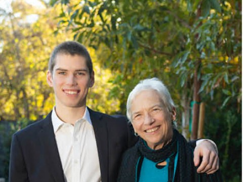 A grandson with his arm around his grandmother