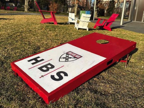 Harvard Business School logo on a campus cornhole board
