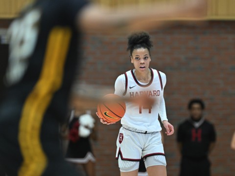 Harmoni Turner '25 brings the basketball up the court.
