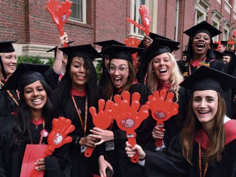 Harvard students in caps and gowns enjoying Commencement
