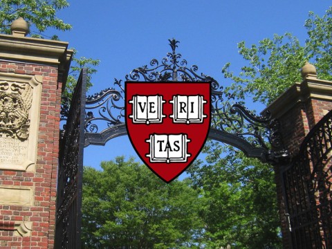 An open gate with the Harvard Logo over it