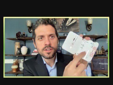 Michael Mina holds up a rapid test during a Zoom call with journalists