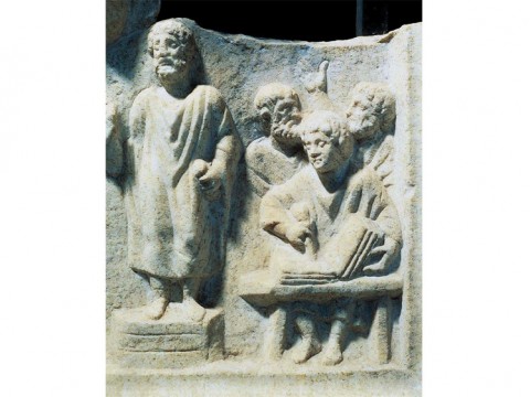 Photograph of a carved relief showing orator dictating to a scribe, from the fourth-century Roman Temple of Hercules at Ostia Antica