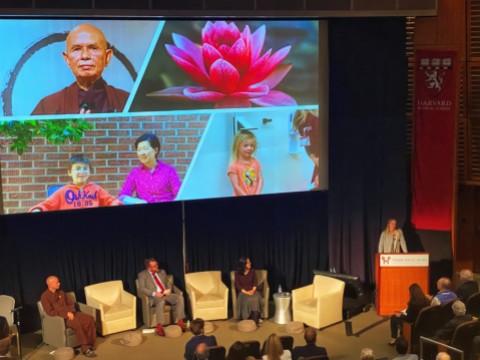 Alia Crum presents about mindfulness in allergy oral immunotherapy. Thich Nhat Hanh is on the top left of the slide. 