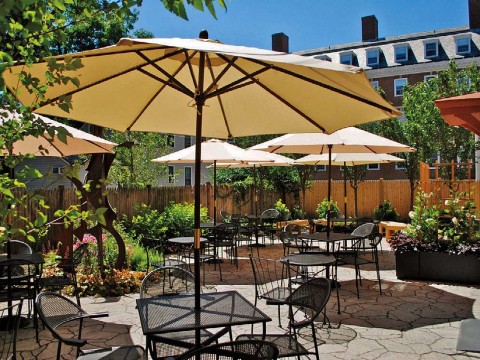 sunny patio with umbrellas over tables