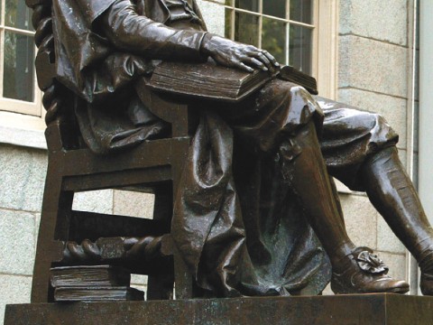The John Harvard statue, with books at hand