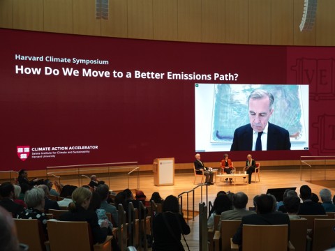 A plenary session at the Harvard Climate Symposium featured Jeremy Grantham, Janet McCabe, Gillian Tett (moderating), and via video link, Mark Carney.